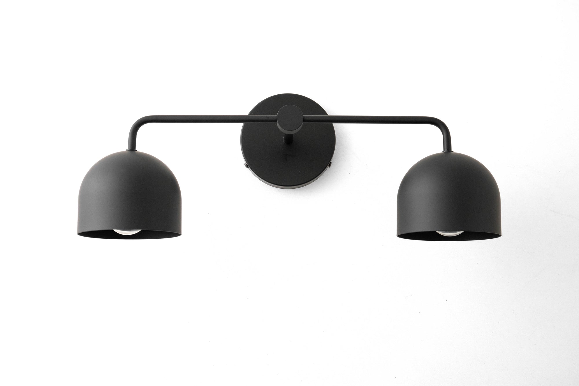 Mid-century modern black metal vanity light with two dome-shaped shades and a circular wall mount. - VANITY LIGHT MODEL NO. 2082