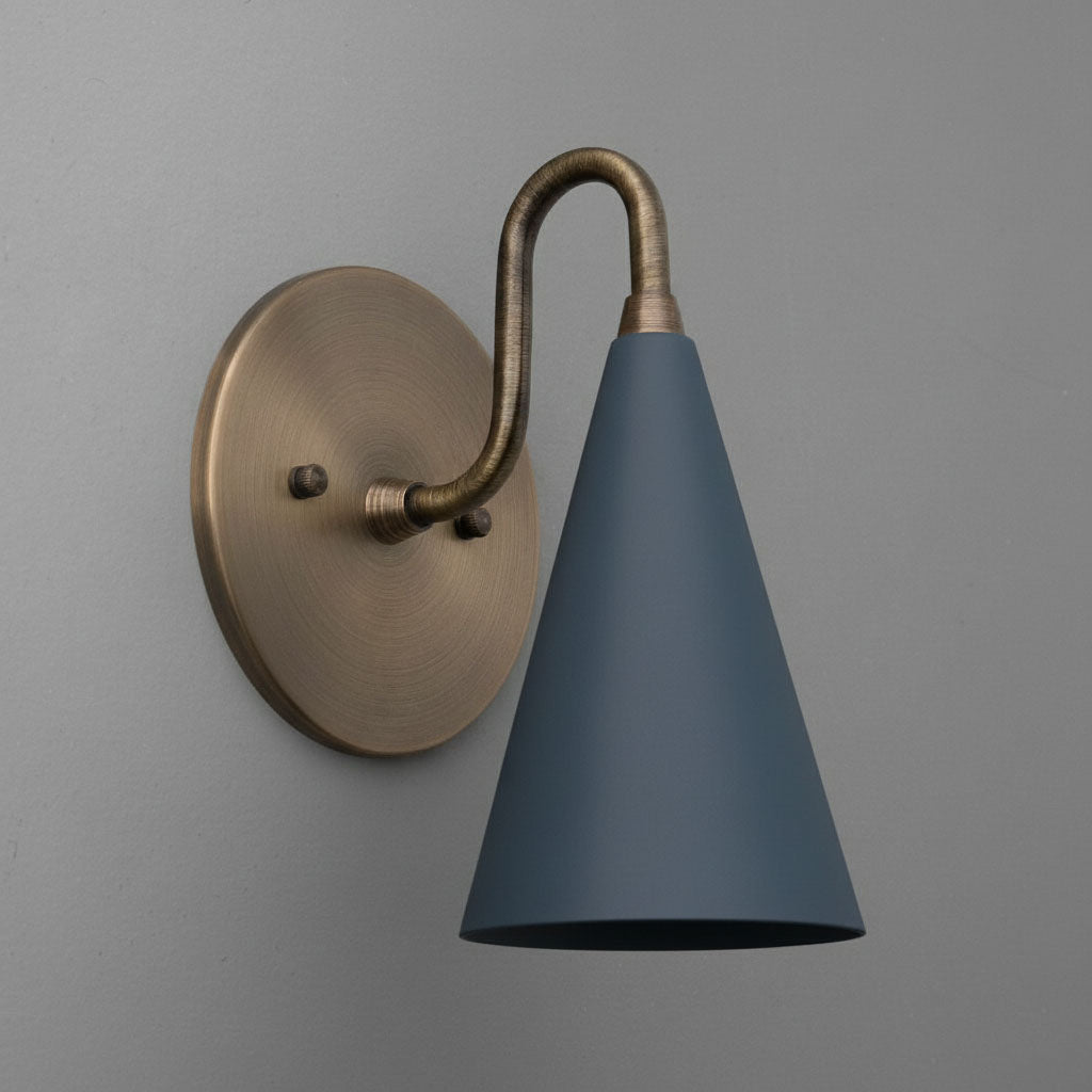 Antique brass sconce with matte coal blue conical shade on gray wall background. - Sconce Model No. 2900