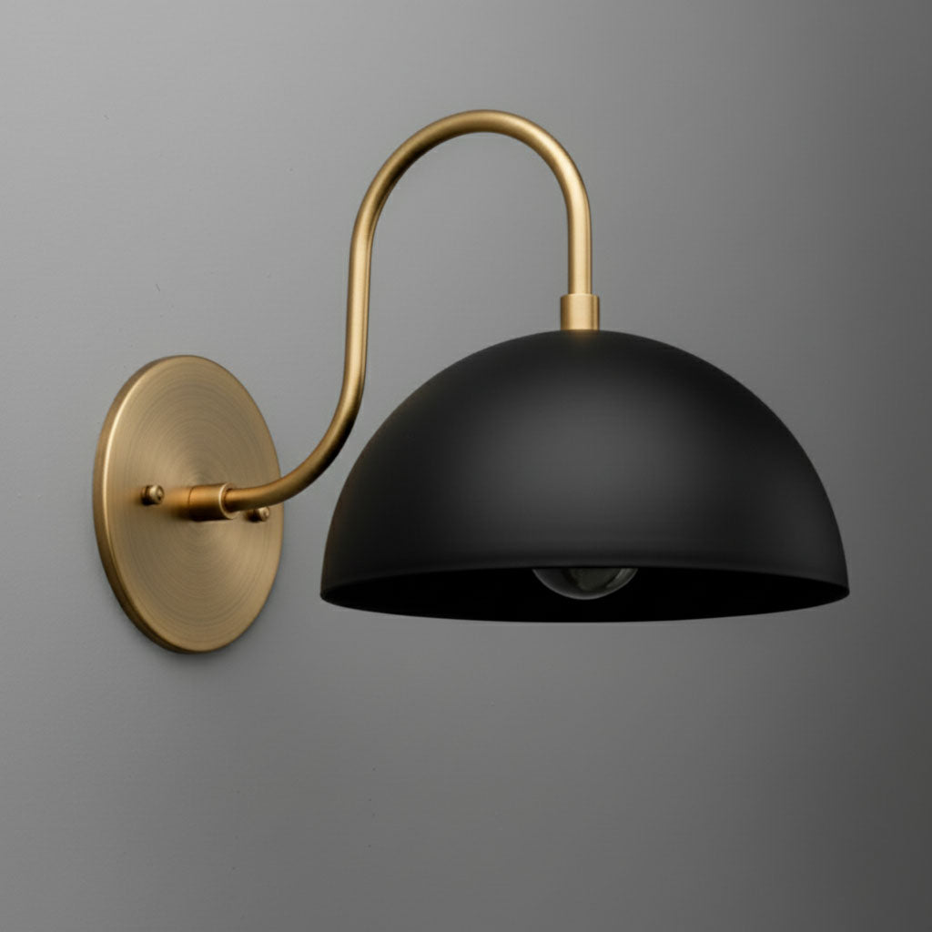 Antique brass wall sconce with matte black dome shade and curved arm on gray background. - SCONCE MODEL NO. 9092