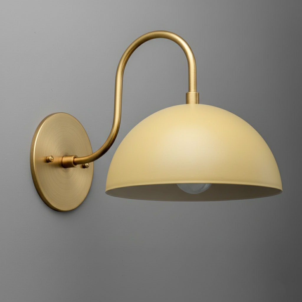 Antique brass wall sconce with smooth cream dome shade and curved arm mounting. - SCONCE MODEL NO. 9092