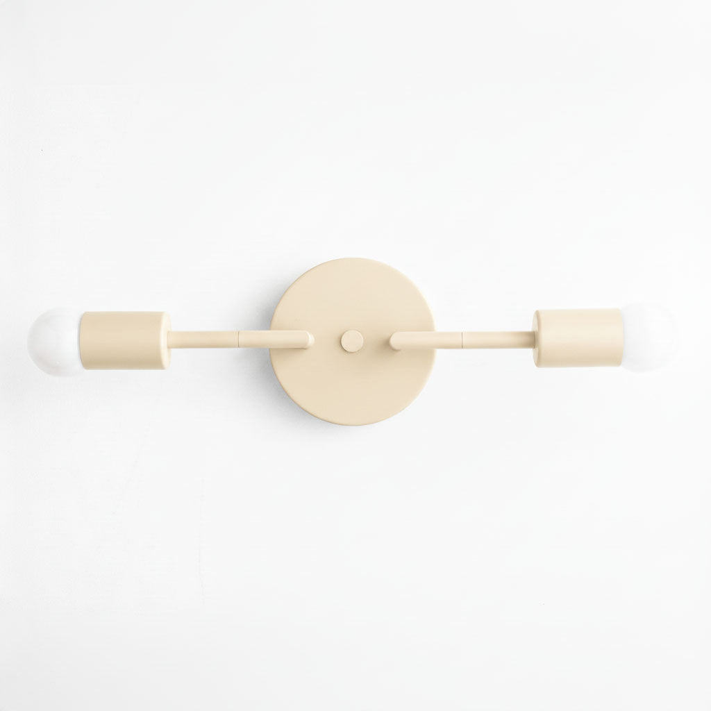 Mid-century modern cream-colored 2-bulb vanity light with bare bulbs and round wall mount. - VANITY LIGHT MODEL NO. 1938