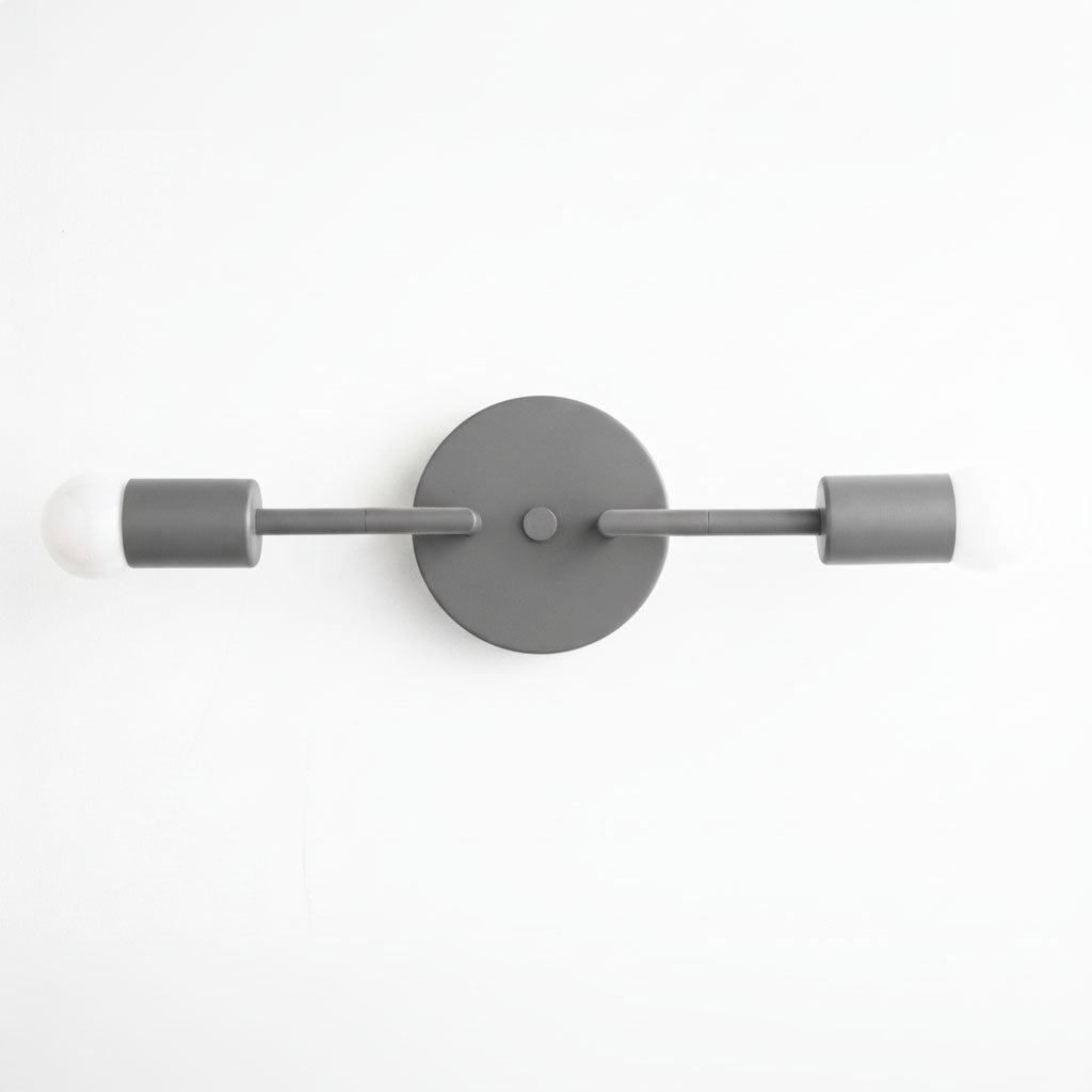 Mid-century modern two-bulb vanity light in matte gray with cylindrical sockets and round wall plate. - VANITY LIGHT MODEL NO. 1938