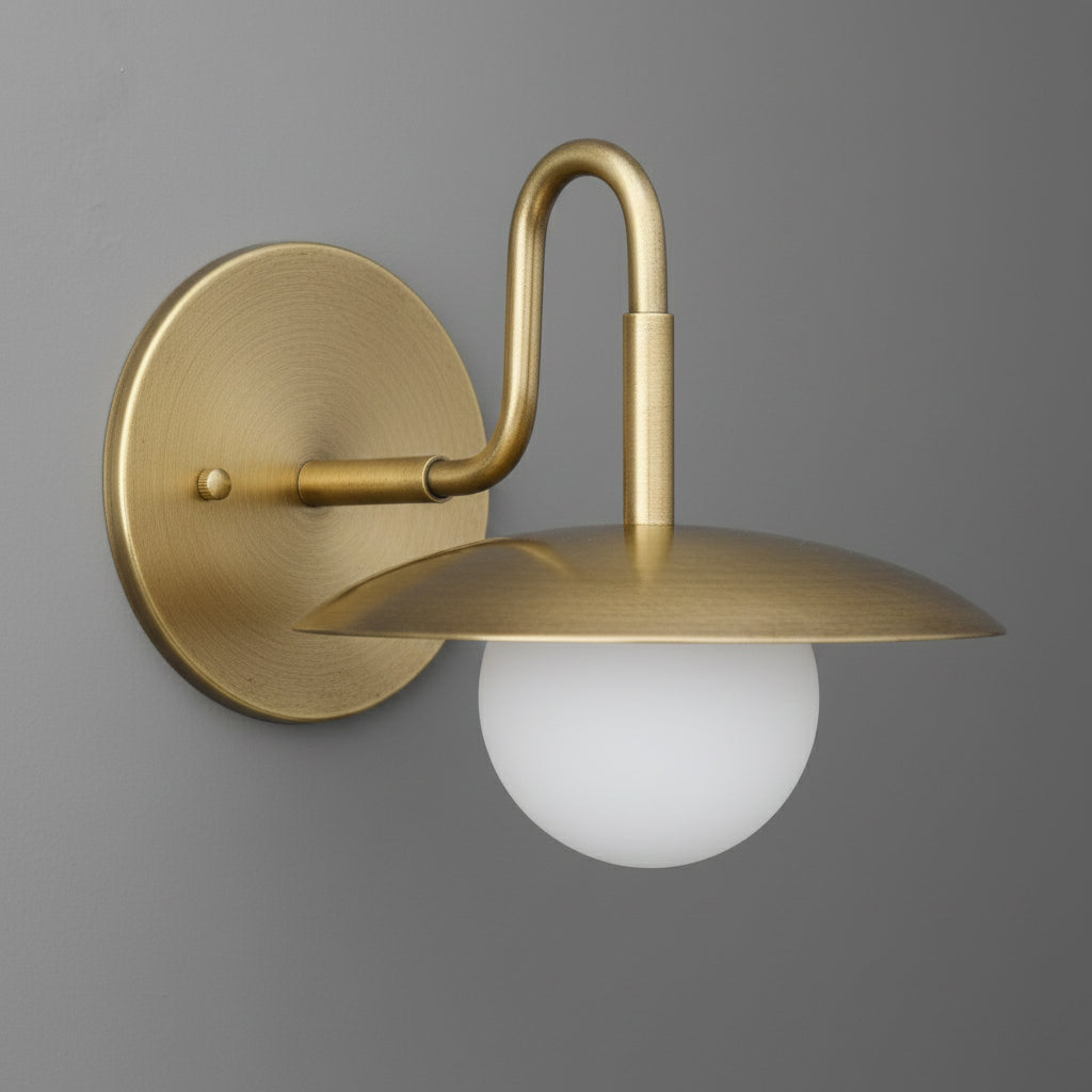 Matte gold metal wall sconce with curved arm and frosted white globe shade. - SCONCE MODEL NO. 1078