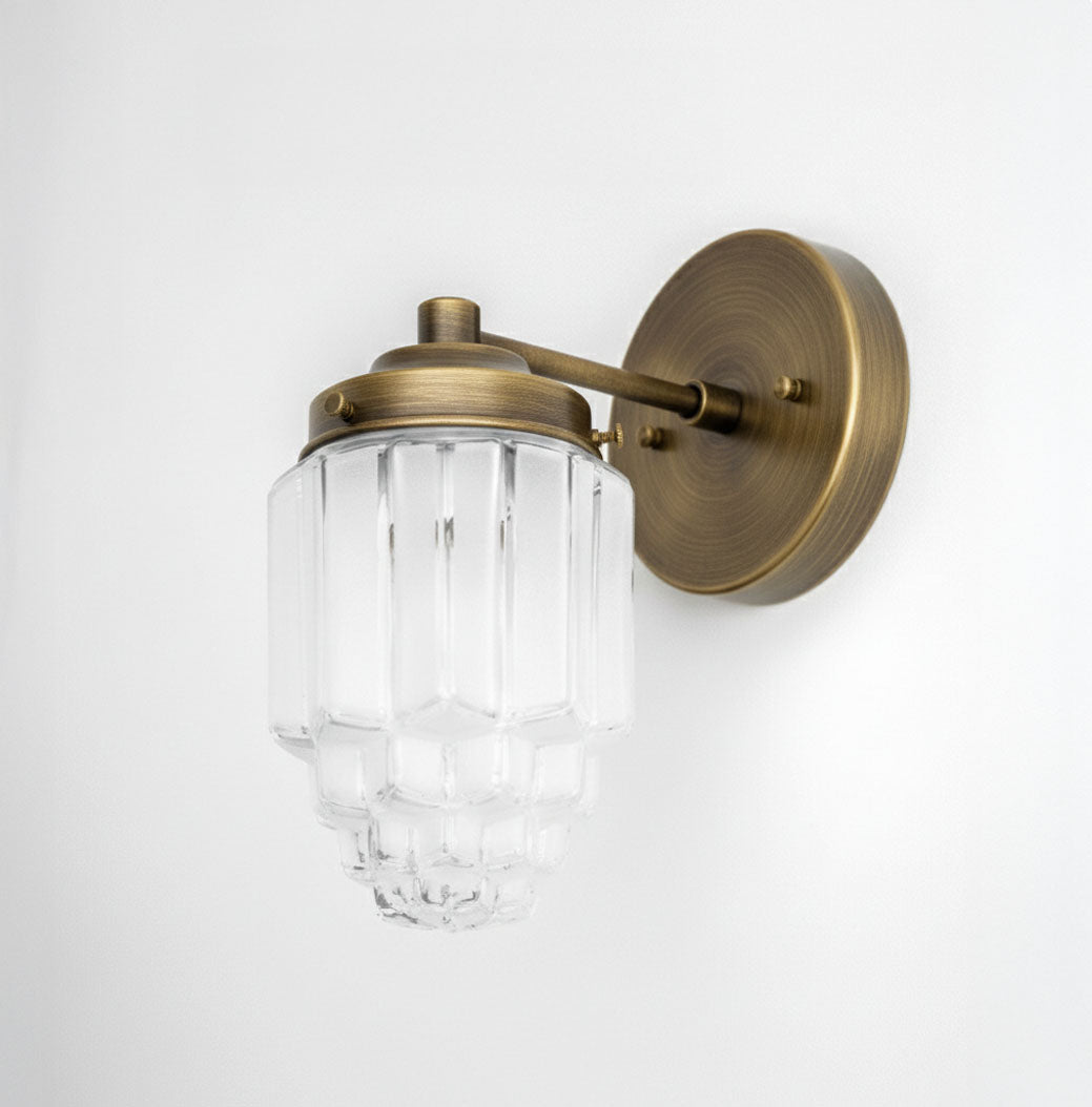 Art Deco wall sconce with tiered clear glass globe and raw brass finish mounting plate and arm. - SCONCE MODEL NO. 6130