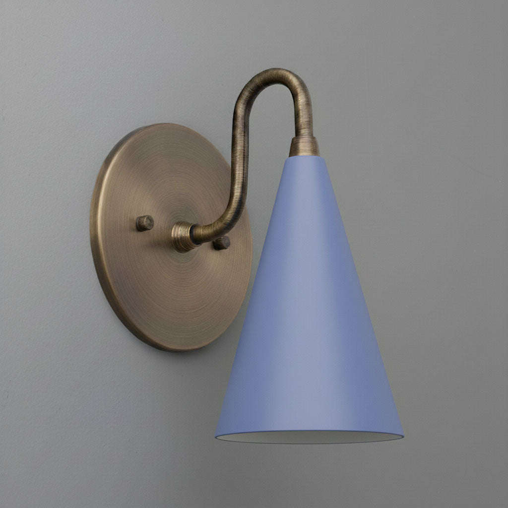 Sconce with antique brass finish and matte periwinkle conical shade against gray wall background. - Sconce Model No. 2900