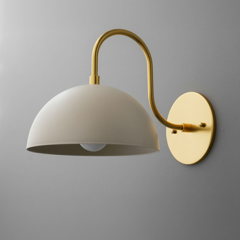 Antique brass wall sconce with cream dome shade and curved arm mount. - SCONCE MODEL NO. 9092