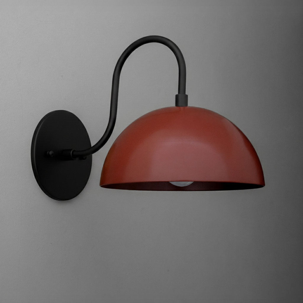 Matte black metal wall sconce with curved arm and dome-shaped brick red shade. - SCONCE MODEL NO. 9092