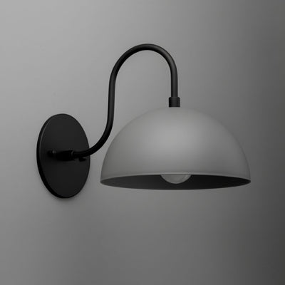 Black metal wall sconce with curved arm and matte gray dome shade. - SCONCE MODEL NO. 9092