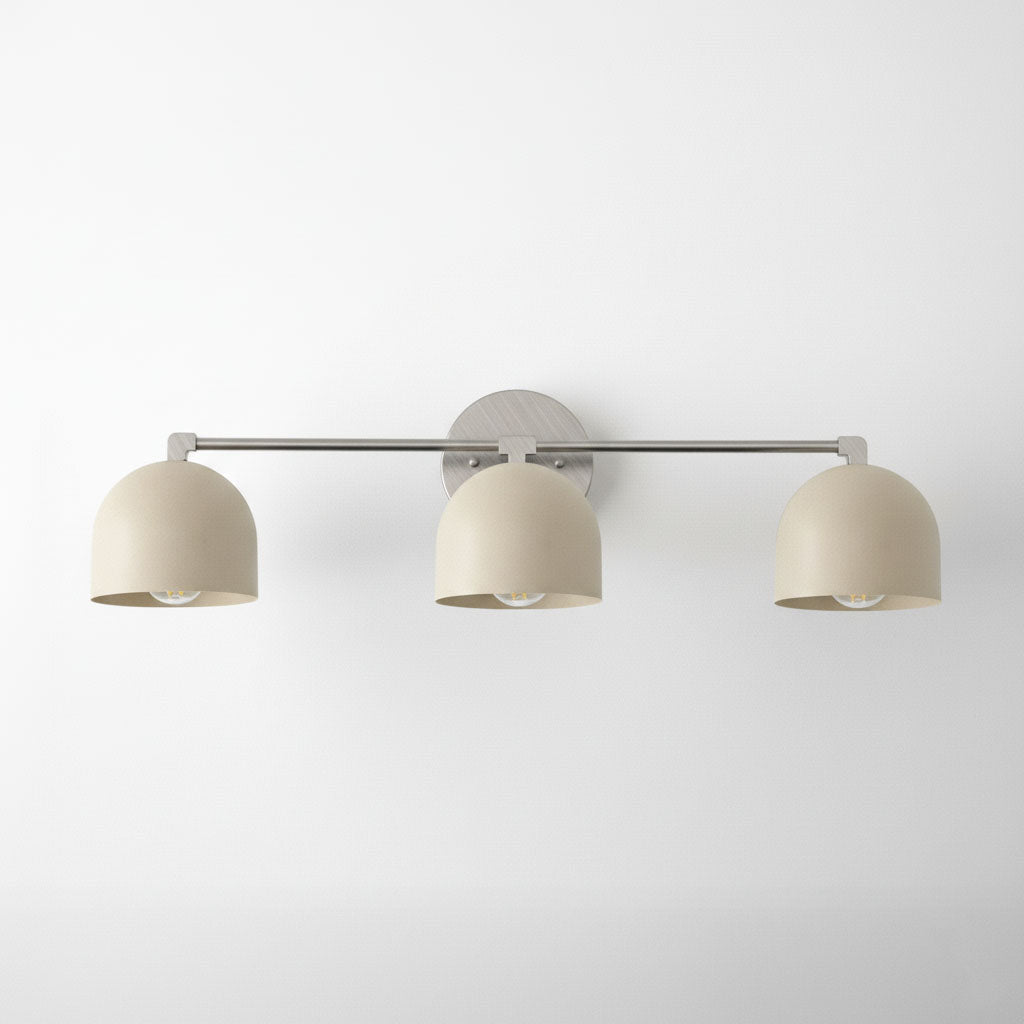 Three-bulb vanity light with cream metal shades and brushed nickel finish wall mount. - VANITY LIGHT MODEL NO. 7565