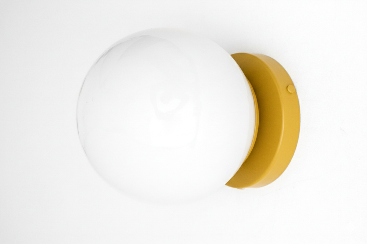 Mid-century modern wall sconce with white globe and mustard yellow flush mount base. - SCONCE MODEL NO. 3825