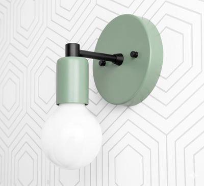 Matte green Scandinavian-style wall sconce with round backplate and exposed bulb on black arm. - SCONCE MODEL NO. 9036