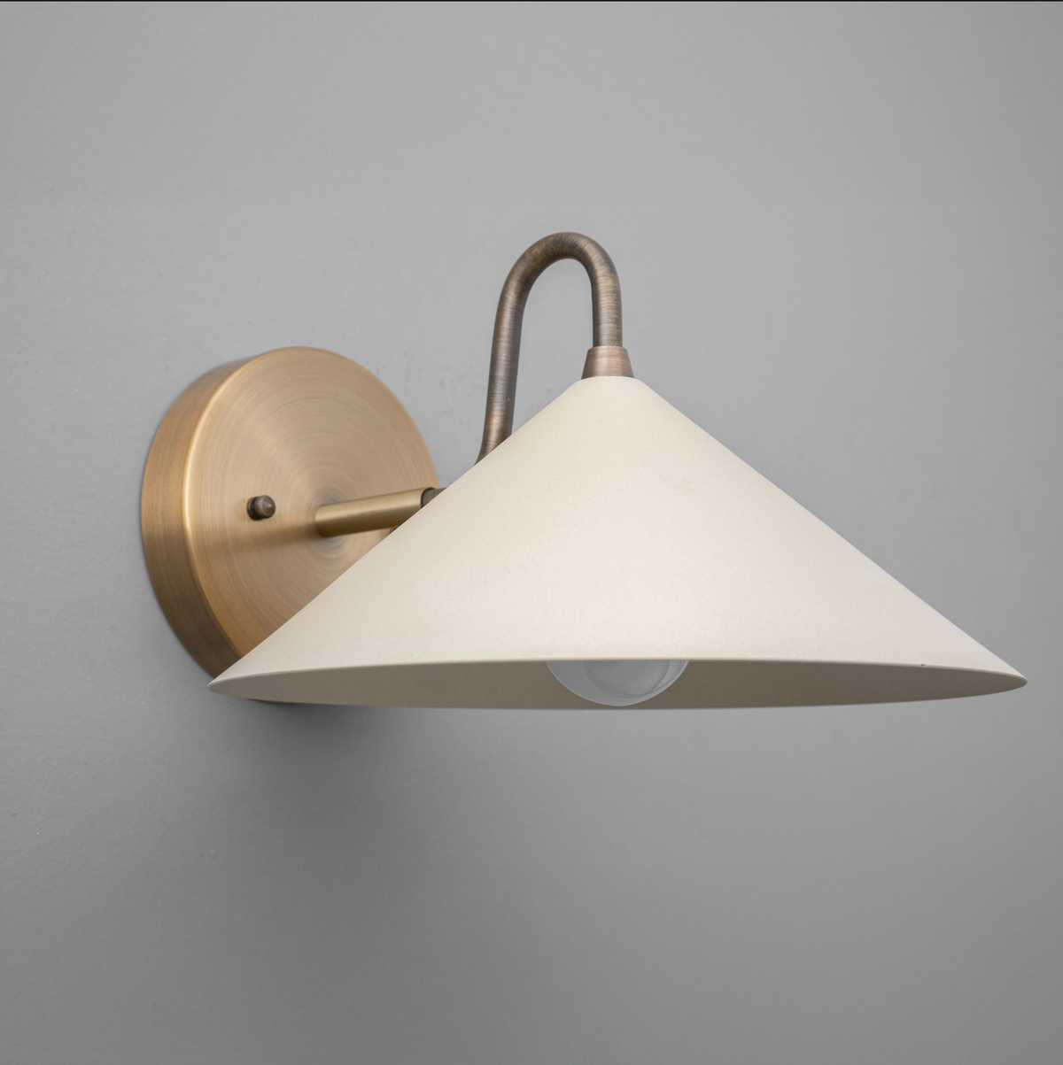 Wall sconce with antique brass finish and wide cream conical metal shade. - SCONCE MODEL NO. 6528