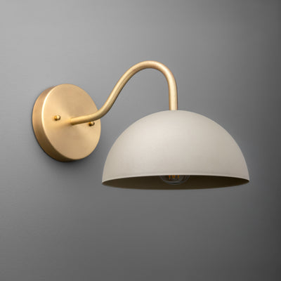 Brushed brass sconce with curved arm and large matte white dome shade, single bulb fixture. - SCONCE MODEL NO. 6678