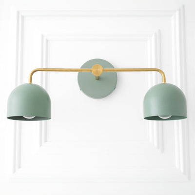 Mid-century modern vanity light with two matte sage green dome shades and a brass horizontal arm. - VANITY LIGHT MODEL NO. 2082