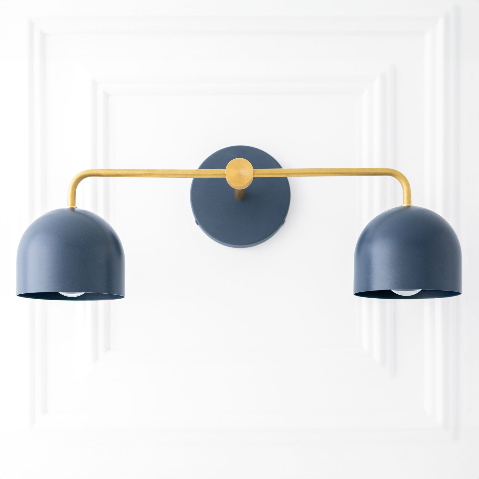 Scandinavian-style vanity light with two deep blue dome shades and a brass-finished horizontal bar. - VANITY LIGHT MODEL NO. 2082