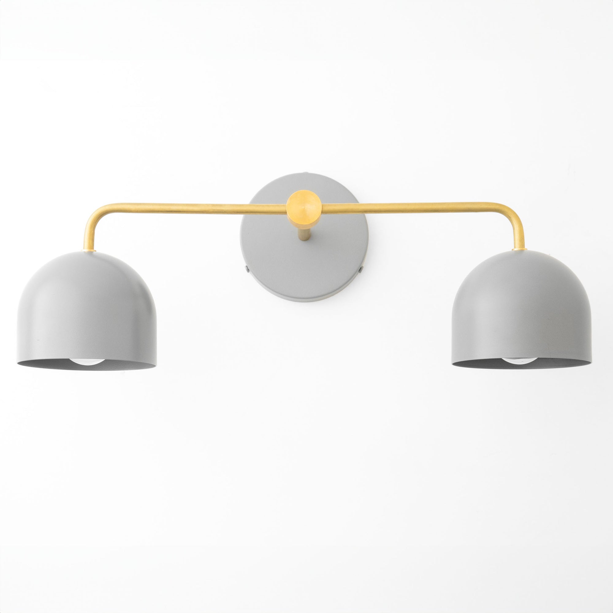 Scandinavian-style vanity light with two matte gray dome shades and a gold metal arm mounting on a round wall plate. - VANITY LIGHT MODEL NO. 2082