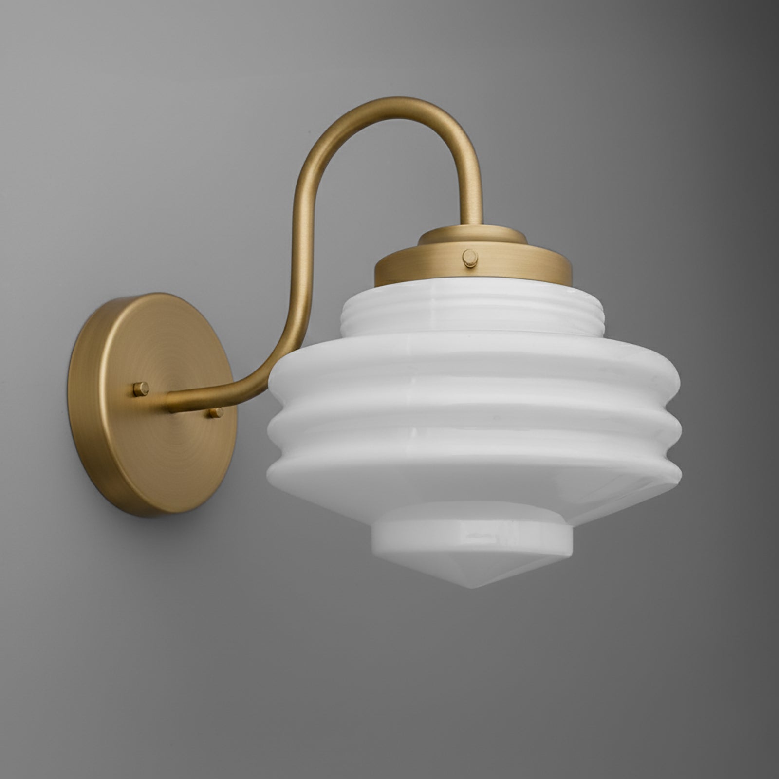 Brushed brass wall sconce with curved arm and tiered frosted white glass shade. - SCONCE MODEL NO. 1096