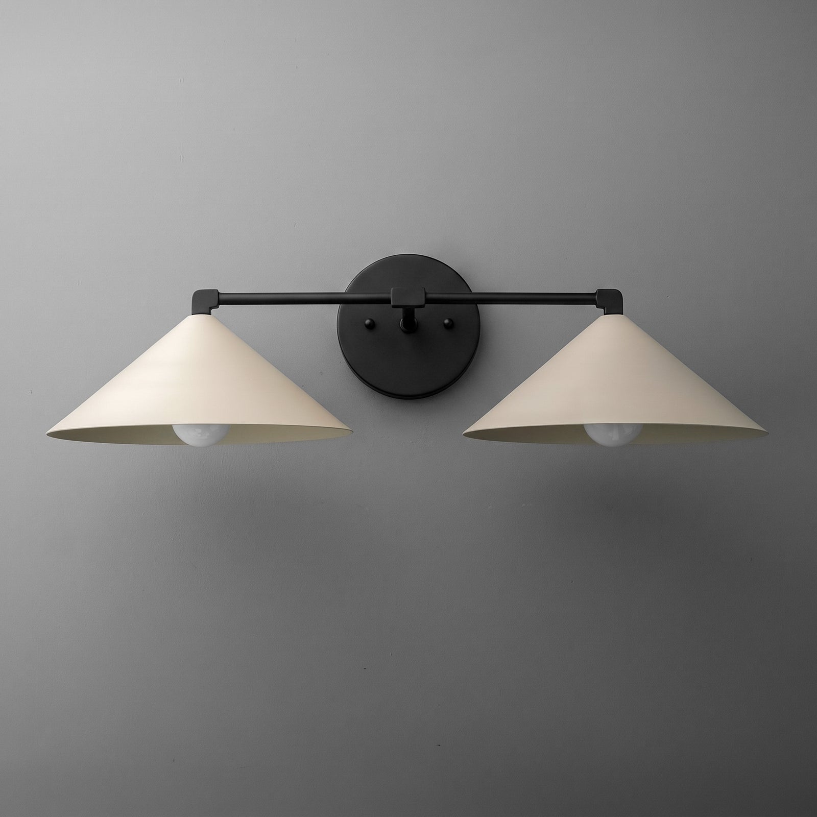 Two-light vanity light in Black with wide steel cone shades on a straight arm and a round wall plate. - VANITY LIGHT MODEL NO. 1185