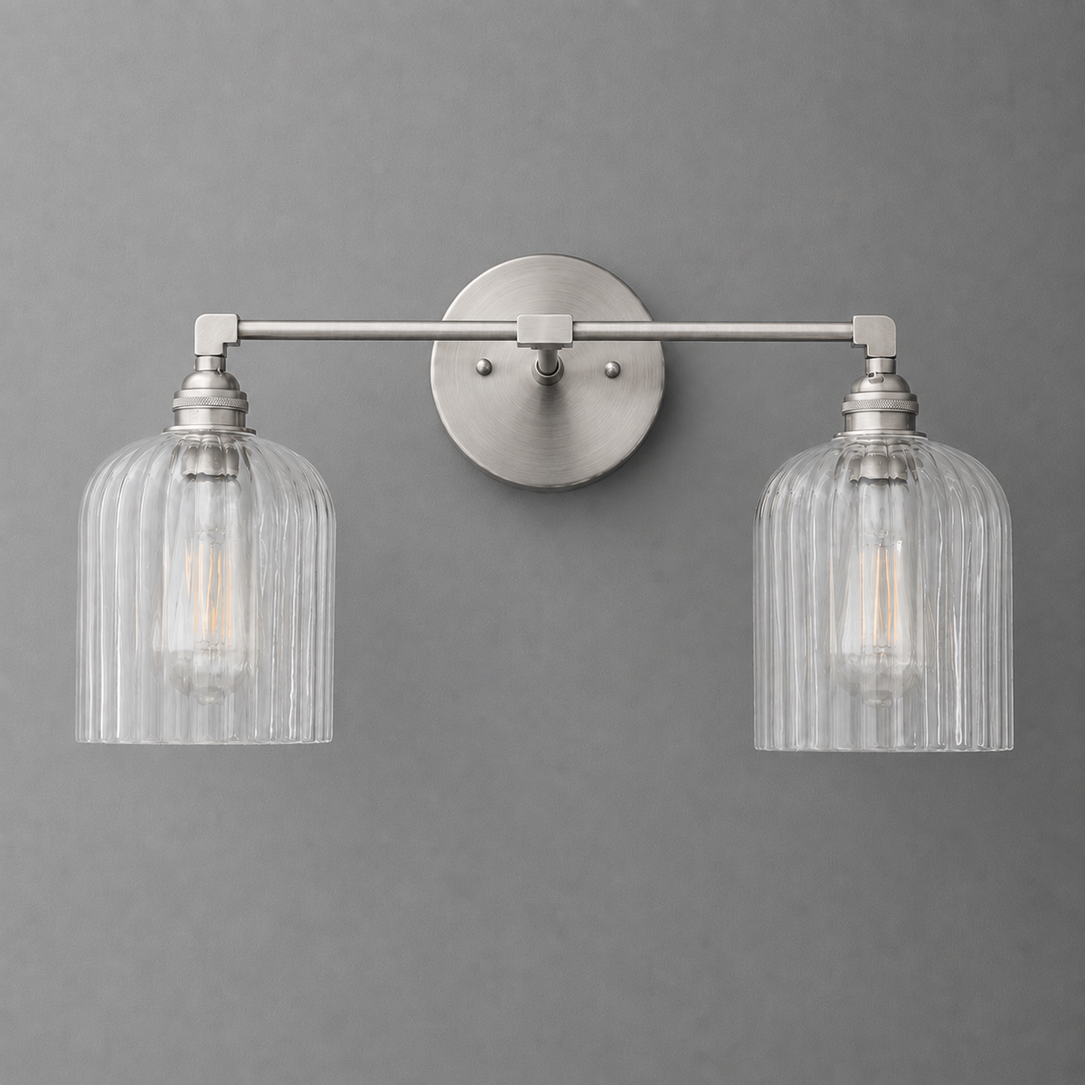 Brushed nickel vanity light with two ribbed glass shades and exposed filament bulbs. - VANITY LIGHT MODEL NO. 1121