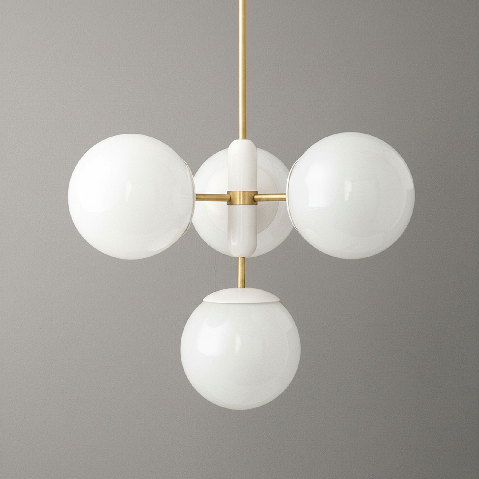Art Deco chandelier with sealed brass finish and four white glass globes suspended on vertical rod. - CHANDELIER MODEL NO. 4321