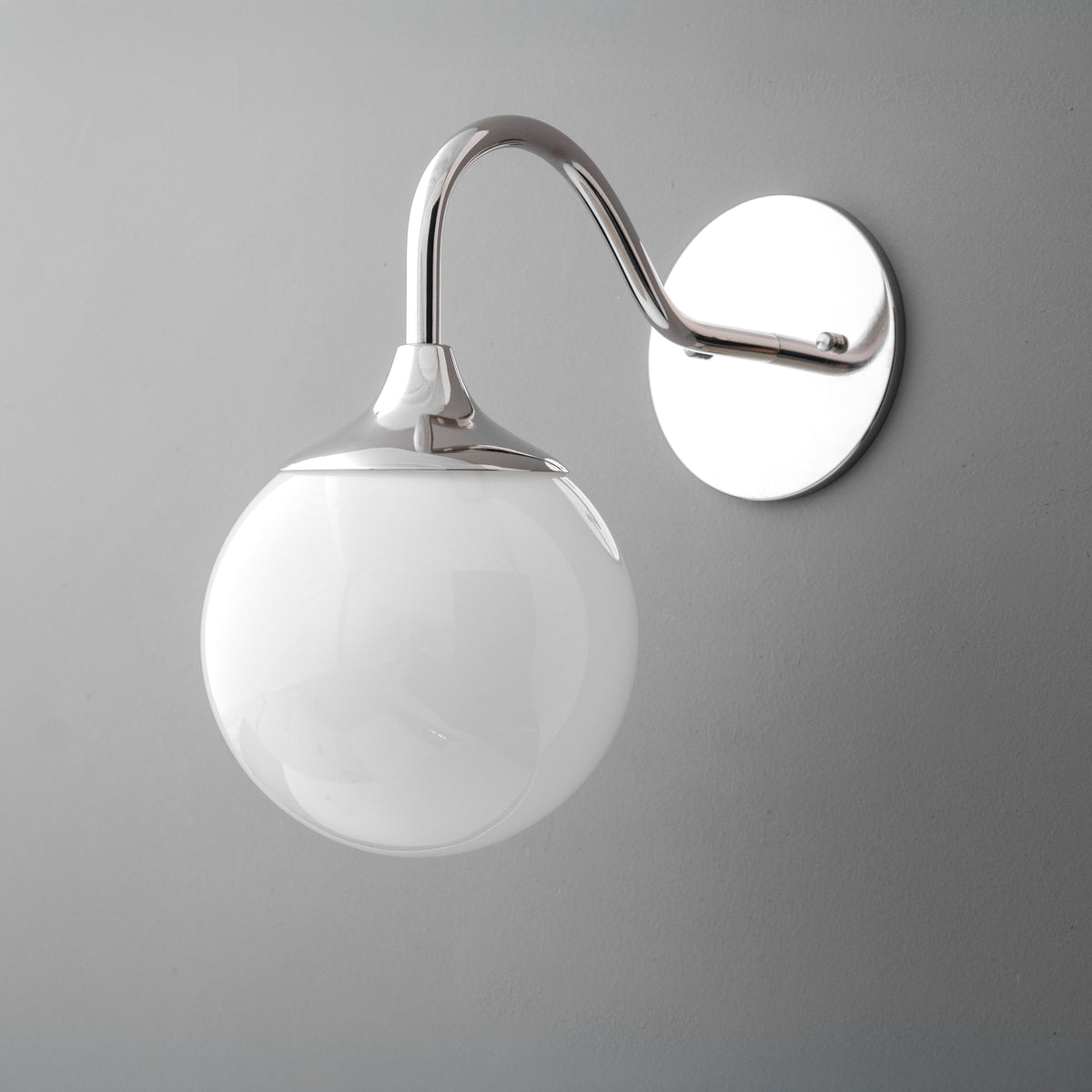 Wall-mounted sconce with polished nickel finish and smooth white glass globe shade. - SCONCE MODEL NO. 8734