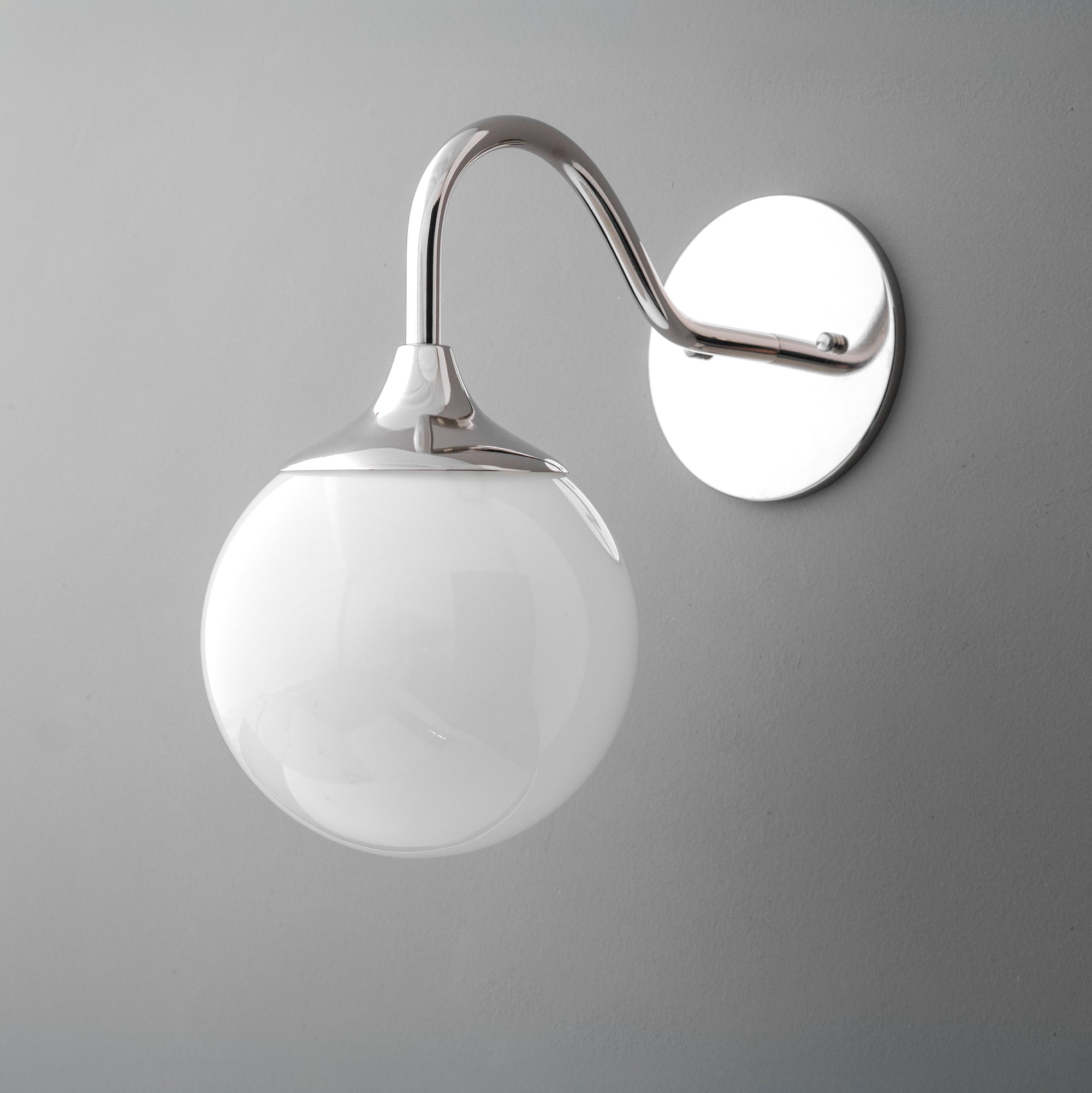 Wall-mounted sconce with polished nickel finish and smooth white glass globe shade. - SCONCE MODEL NO. 8734