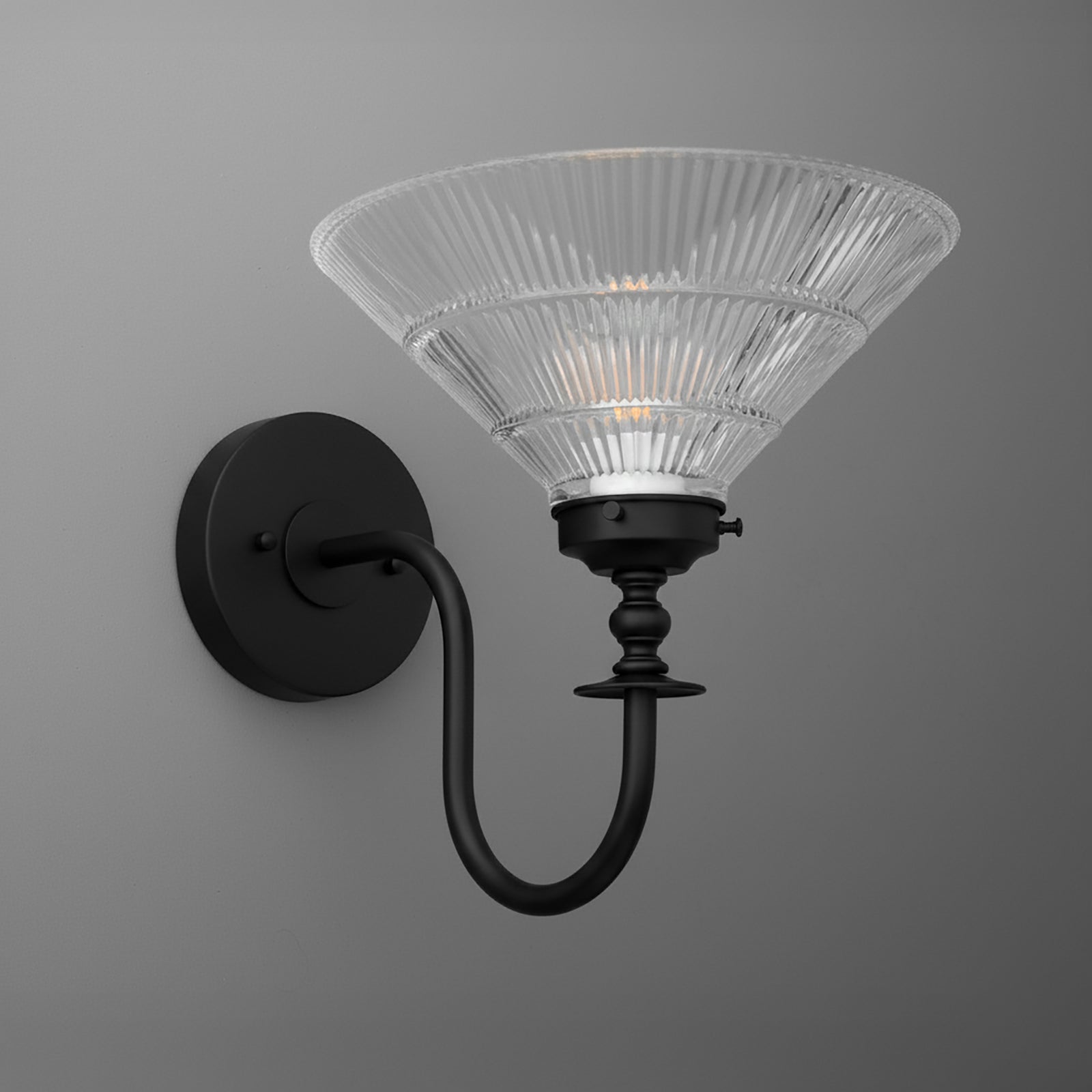 Black metal wall sconce with curved arm and flared ribbed clear glass shade. - SCONCE MODEL NO. 8036