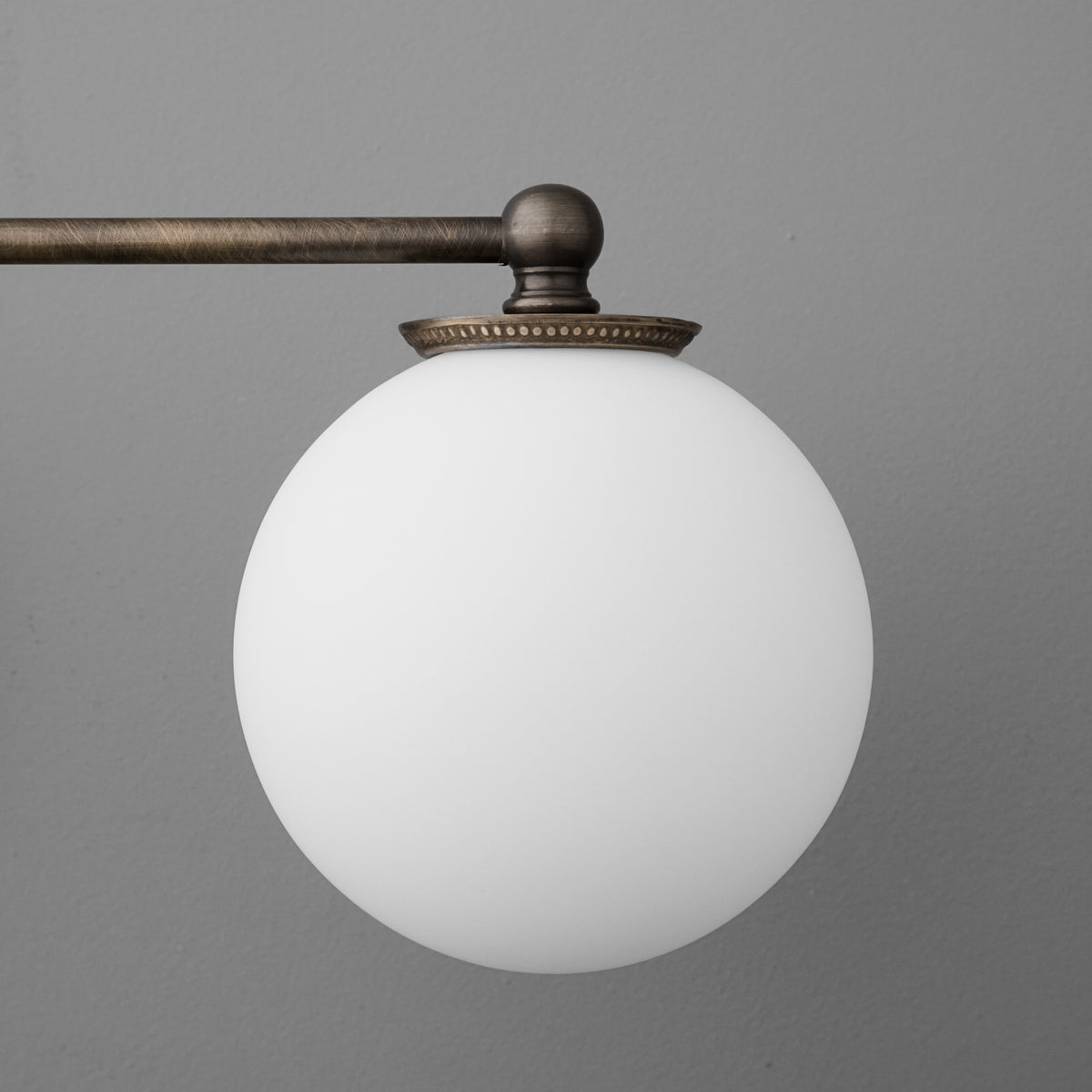 Two-bulb vanity light with antique bronze metal arm and frosted white glass globe shades. - VANITY LIGHT MODEL NO. 1153