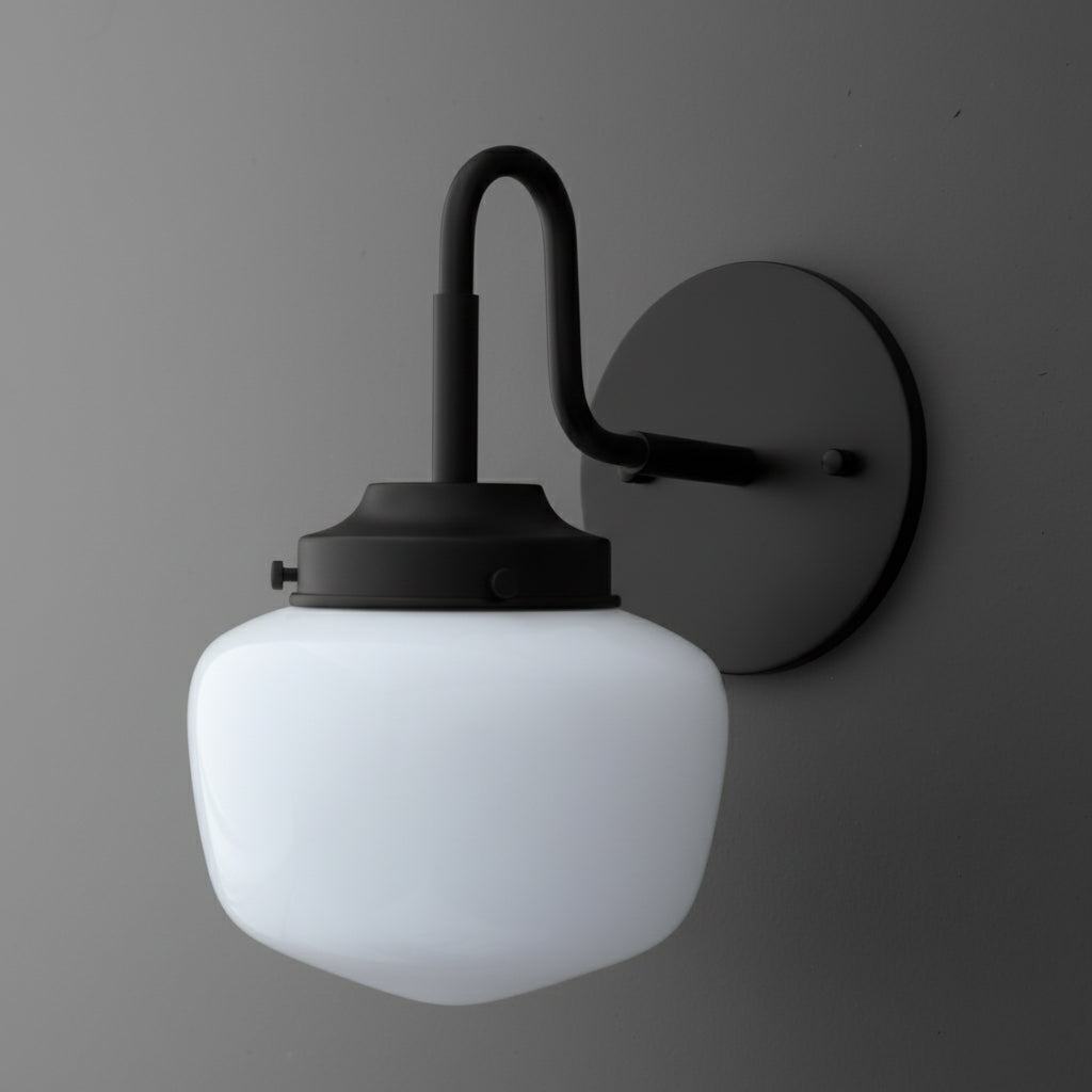 Black metal wall sconce with curved arm and white frosted glass globe shade. - SCONCE MODEL NO. 1084