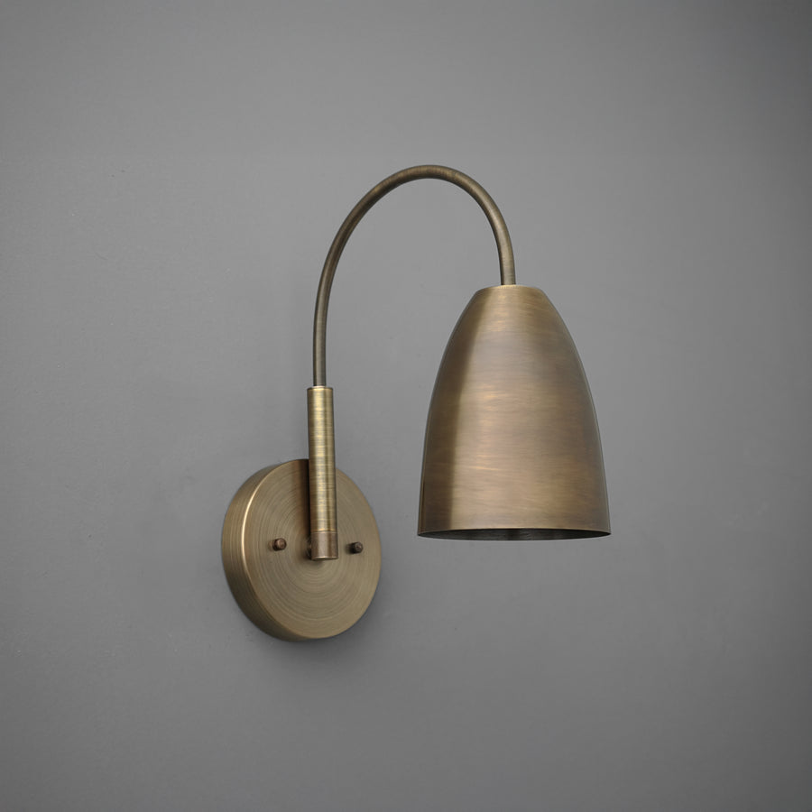 Antique brass wall sconce with curved arm and dome-shaped shade against gray background. - SCONCE MODEL NO. 2977