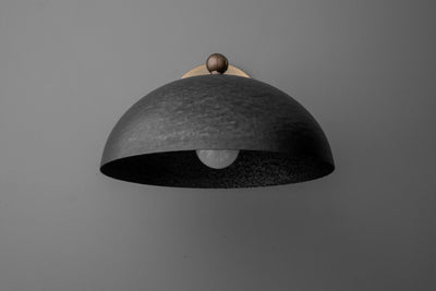 Black dome-shaped metal sconce with textured finish and small brass accent on top. - SCONCE MODEL NO. 3164