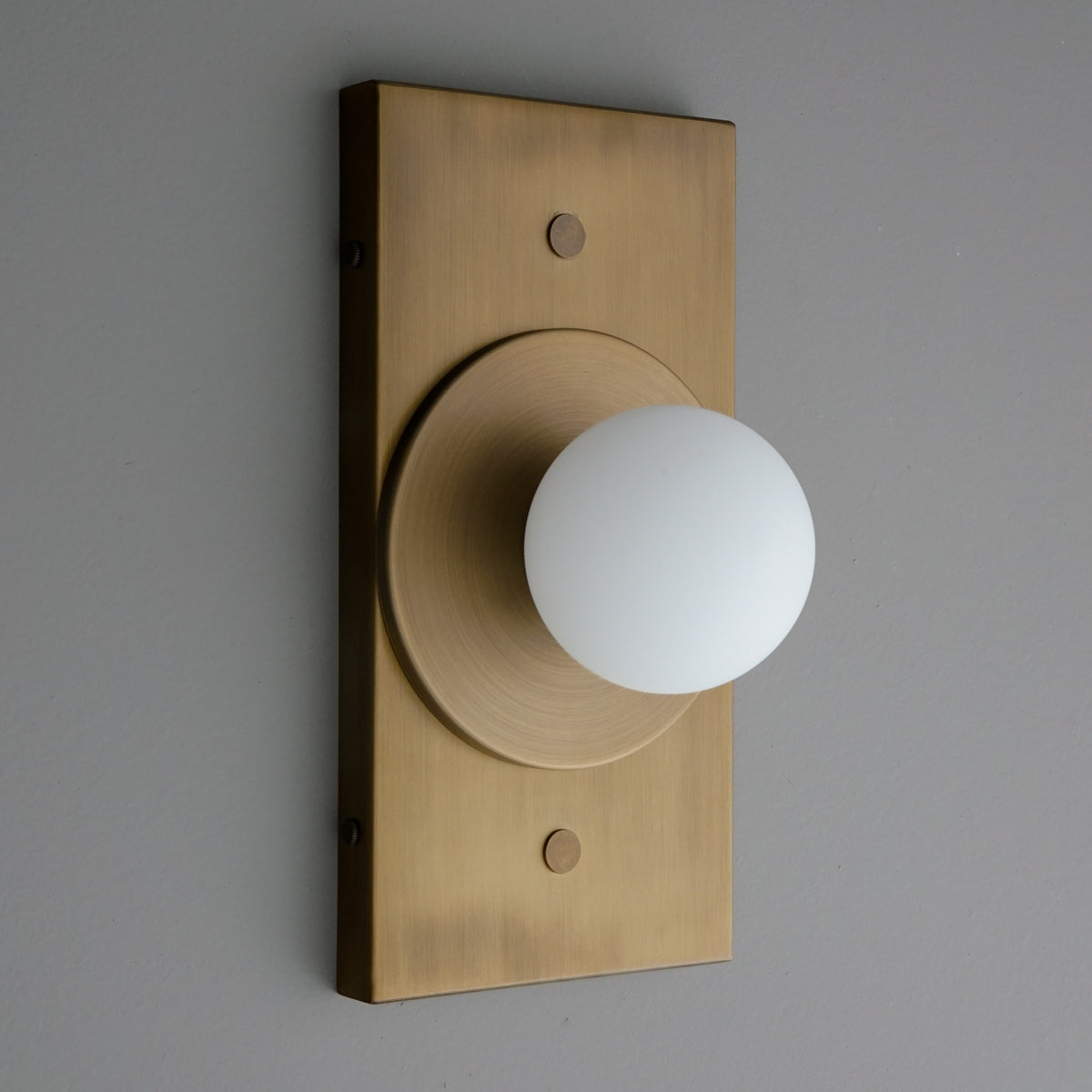 Antique brass rectangular wall sconce with round frosted glass globe light. - SCONCE MODEL NO. 4474