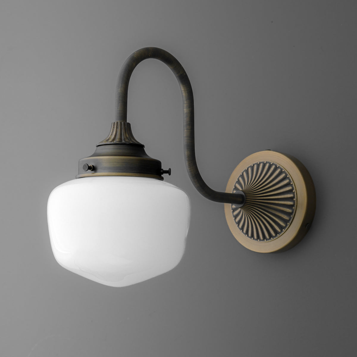 Antique bronze wall sconce with curved arm and frosted white glass shade. - SCONCE MODEL NO. 1061