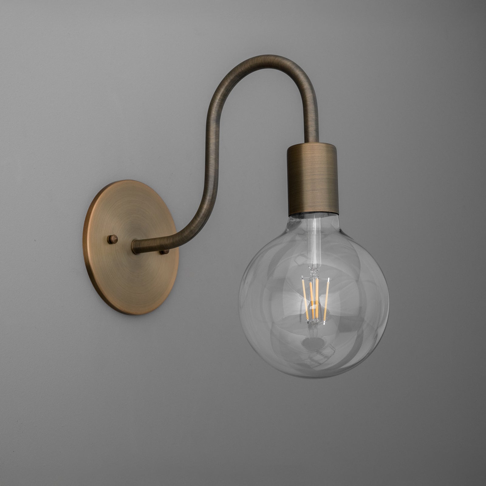 Antique brass finish 1-bulb wall sconce with curved arm and clear globe bulb. - SCONCE MODEL NO. 4753