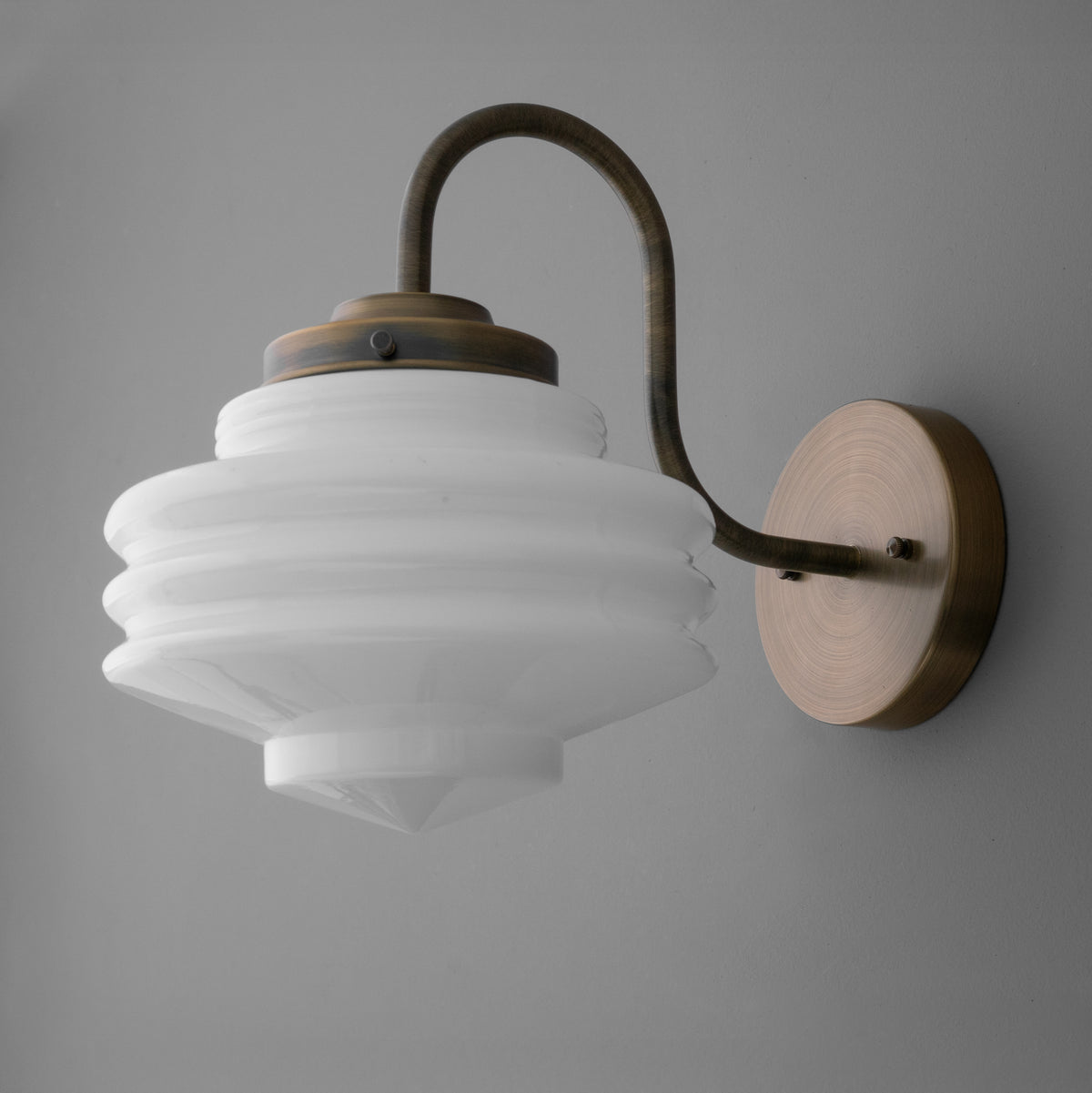 White ribbed glass globe sconce with curved bronze arm and round bronze wall mount. - SCONCE MODEL NO. 1096