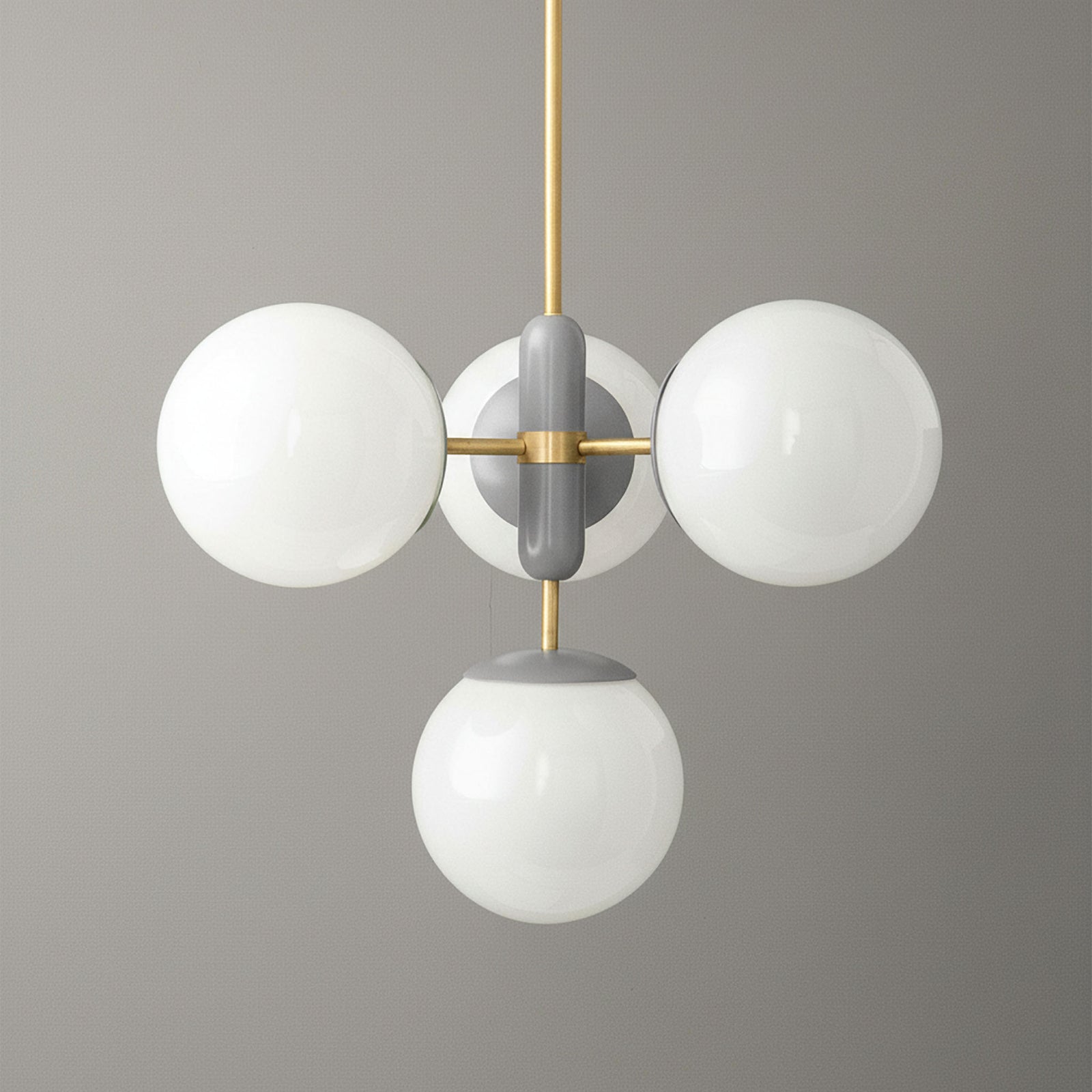 Art Deco chandelier with sealed brass fixture and three white globe lights against gray background. - CHANDELIER MODEL NO. 4321