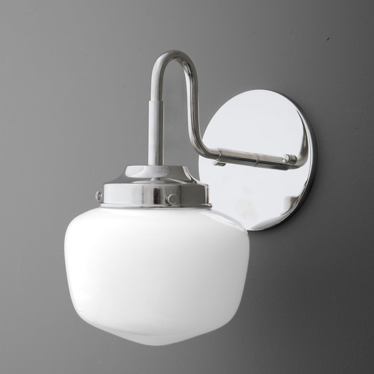 Polished chrome 1-bulb wall sconce with curved arm and frosted white glass shade. - SCONCE MODEL NO. 1084
