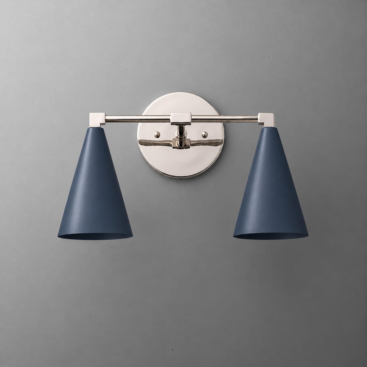Two-light vanity light in Polished Nickel with Coal Blue cone shades on a straight arm and a round wall plate. - VANITY LIGHT MODEL NO. 1184