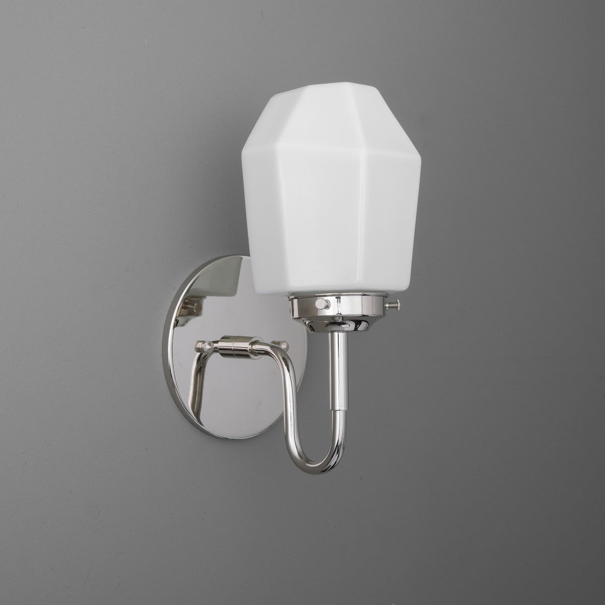 Single-bulb wall sconce with polished chrome curved arm and white faceted glass shade. - SCONCE MODEL NO. 1038