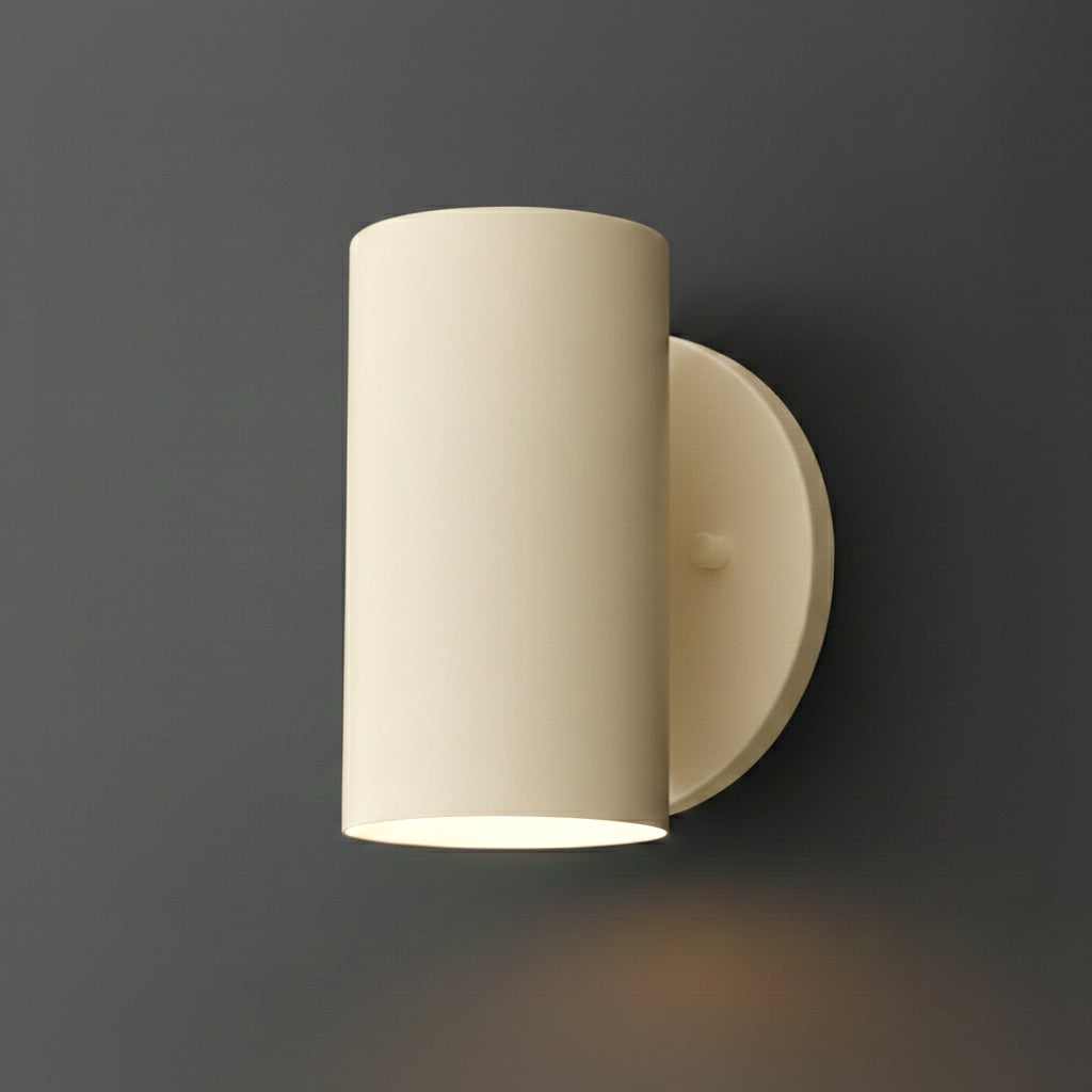 Single-light cylinder sconce in Cream on a round wall plate, casting light downward. - SCONCE MODEL NO. 3836