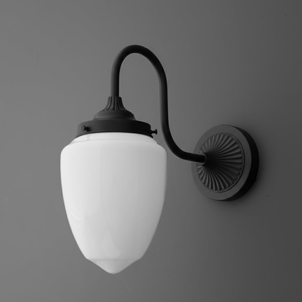 Black metal wall sconce with curved arm and white opaque glass shade in a tapered oval shape. - SCONCE MODEL NO. 1094