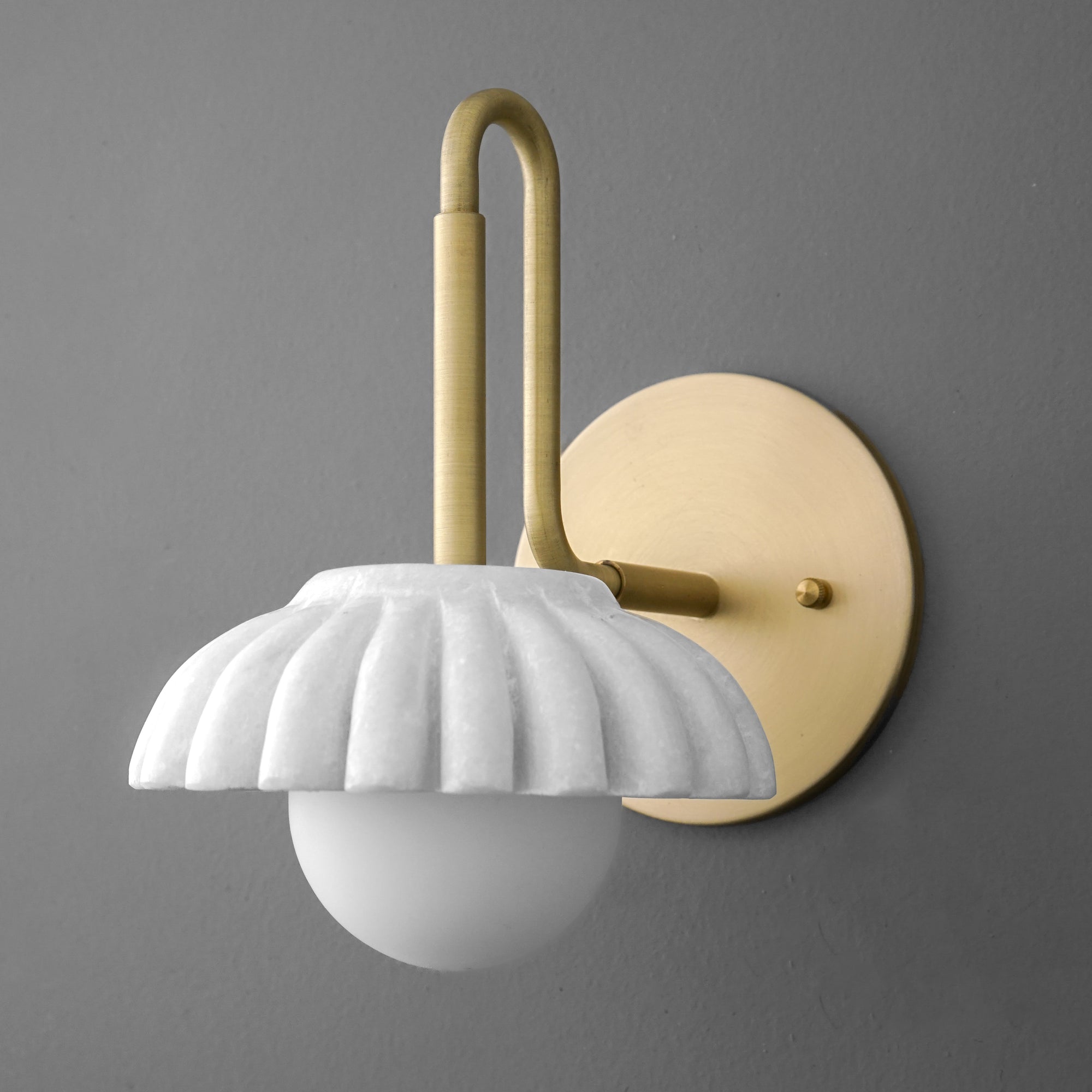 Matte gold metal wall sconce with scalloped white ceramic shade and frosted round bulb. - SCONCE MODEL NO. 8633
