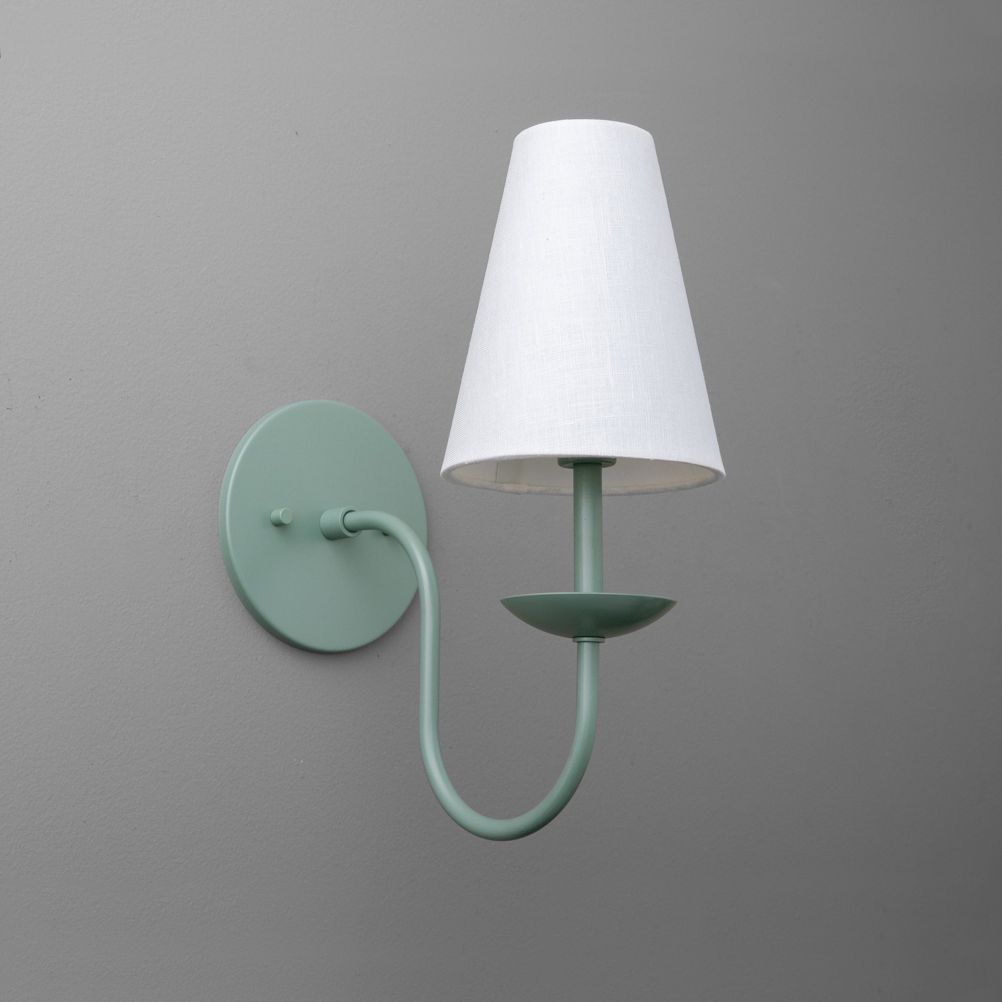 Wall-mounted sconce with soft periwinkle blue curved metal arm and white tapered fabric shade. - SCONCE MODEL NO. 7085