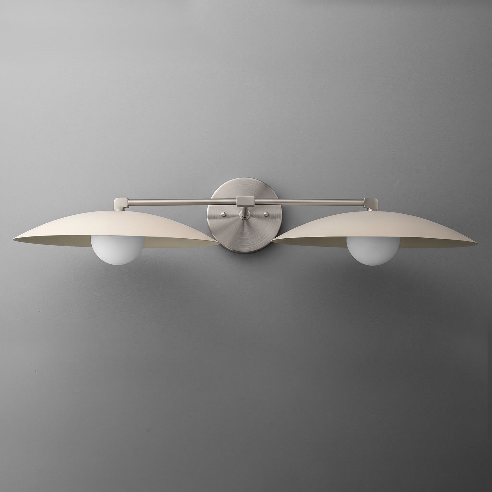 Matte nickel dual-arm vanity light with two round white glass bulbs and flat dome shades. - VANITY LIGHT MODEL NO. 1168