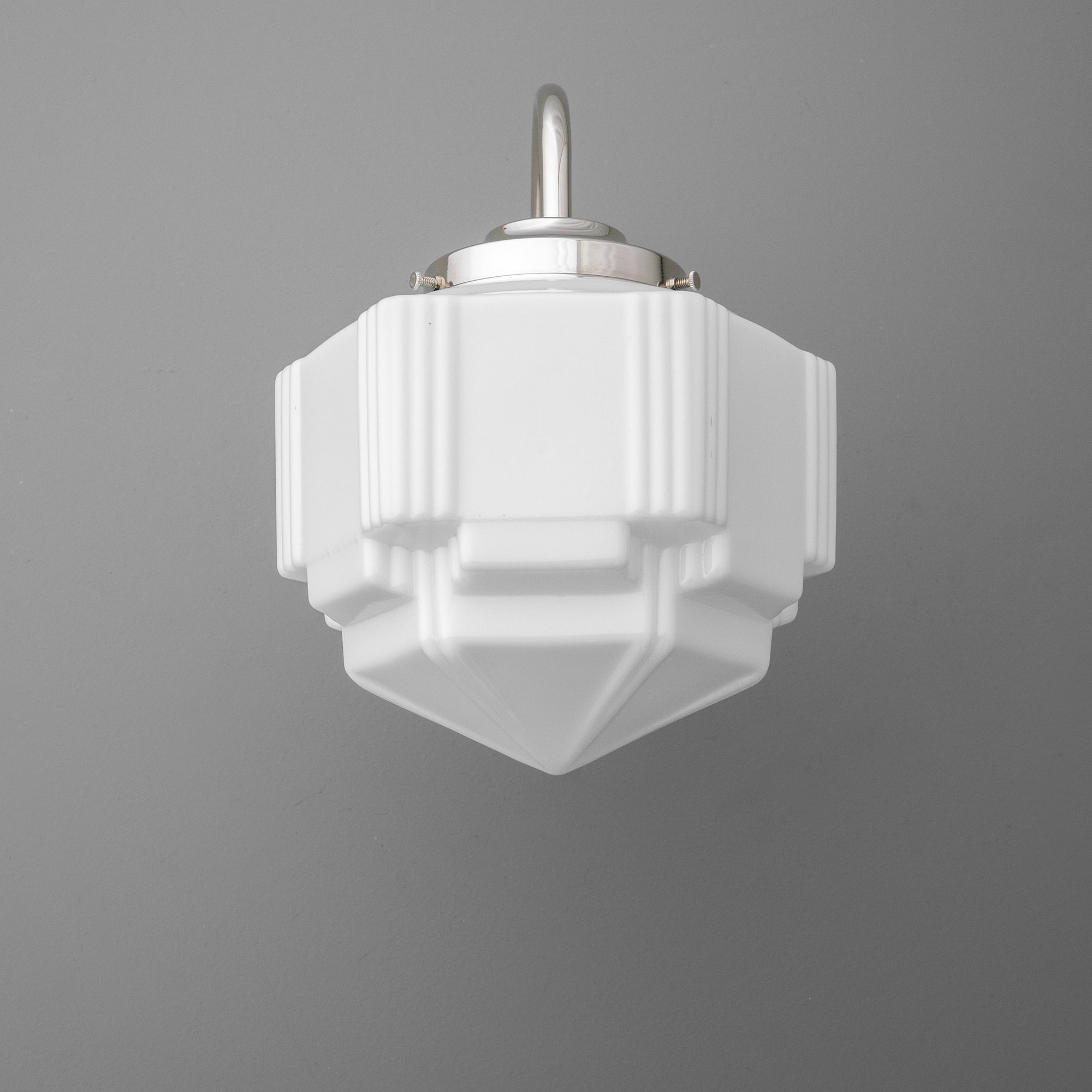 White geometric glass sconce with tiered, faceted design and brushed metal mounting bracket. - SCONCE MODEL NO. 1058