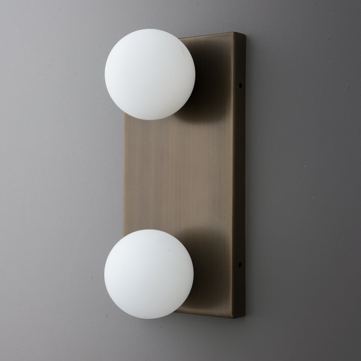 Two-bulb wall sconce with frosted white glass globes on a rectangular brushed bronze metal backplate. - SCONCE MODEL NO. 4016