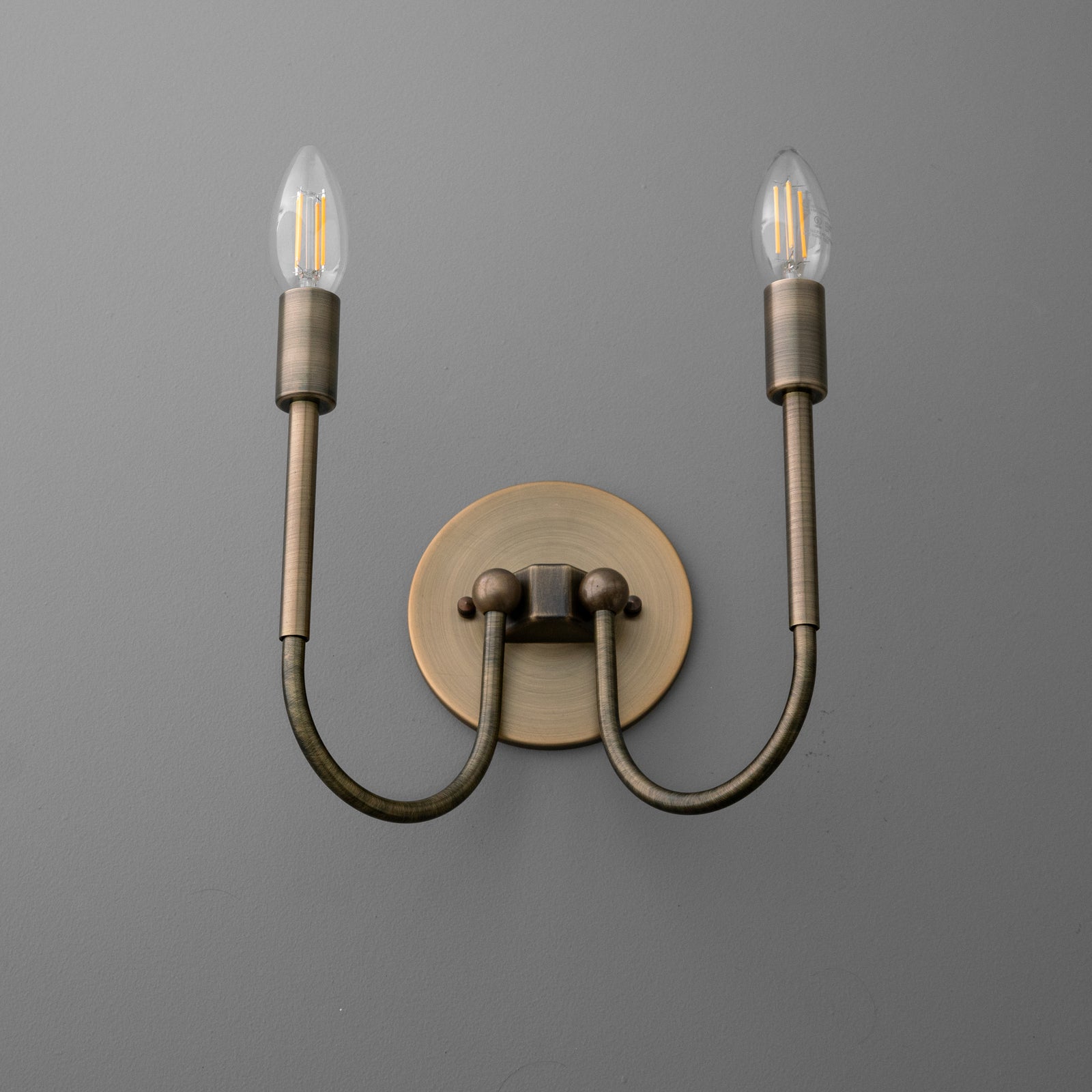 Antique brass double-arm wall sconce with exposed vintage-style filament bulbs. - SCONCE MODEL NO. 4122