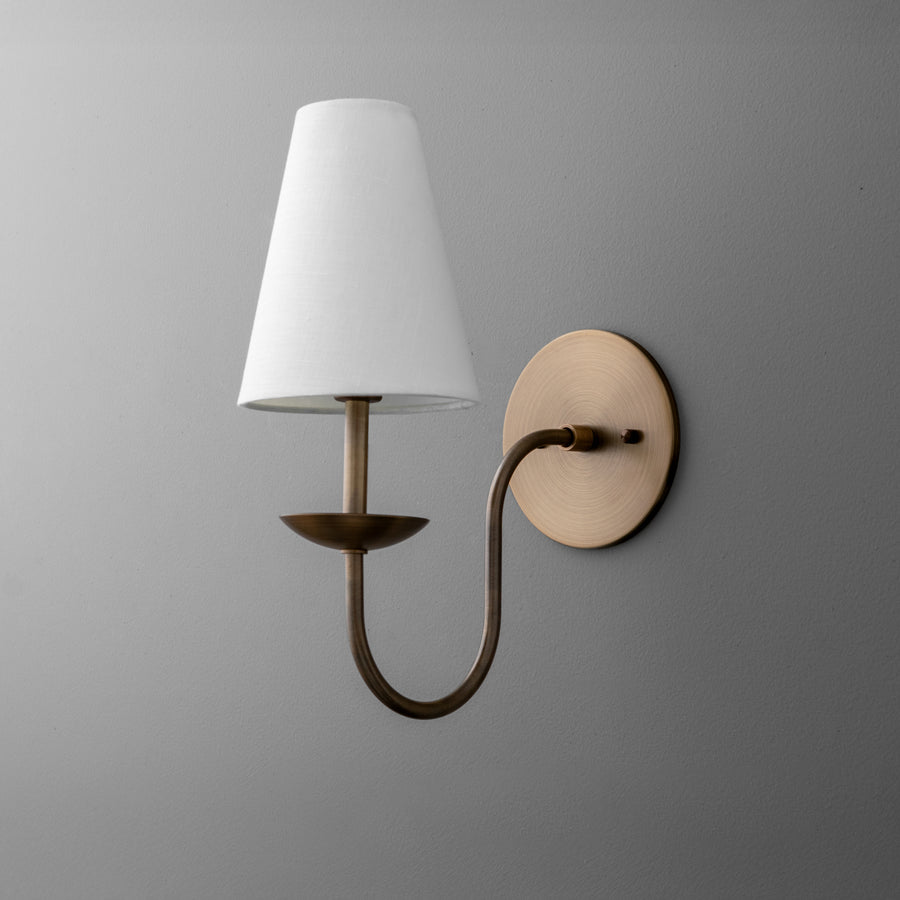Wall sconce with curved antique brass arm and white tapered fabric shade. - SCONCE MODEL NO. 9867