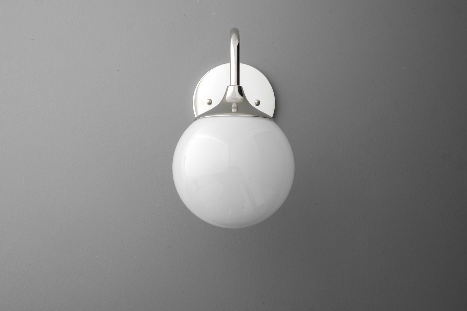 Modern wall sconce with polished nickel finish and white glass globe shade. - SCONCE MODEL NO. 8734