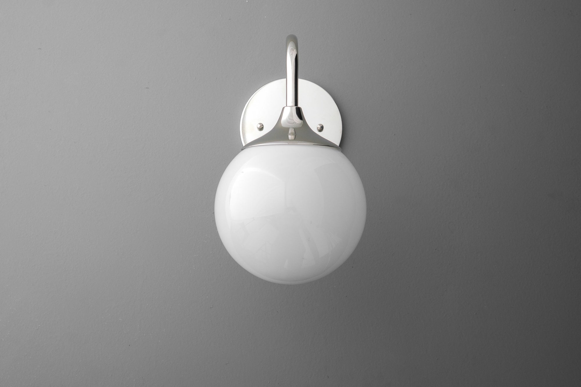 Modern wall sconce with polished nickel finish and white glass globe shade. - SCONCE MODEL NO. 8734